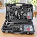 128-piece household tool kit in an open hard case on a kitchen table